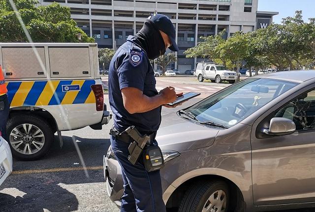 Traffic officer using a mobile device to issue an infringement notice
